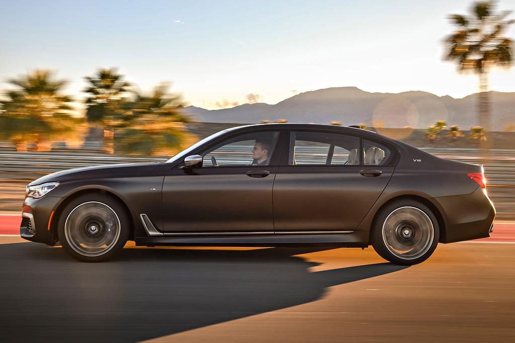BMW 7-Series driving at golden hour